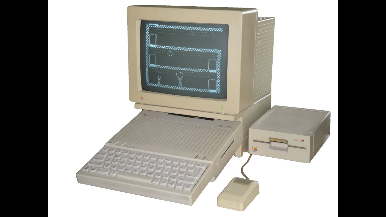 An old 1980's Apple Computer running a game that resembles Donkey Kong.